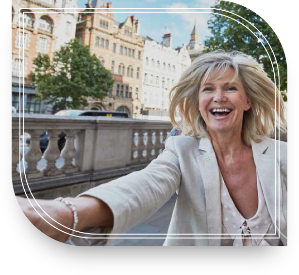 A happy woman running through the street with a reaching hand.